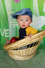 Healthy baby holding red apple