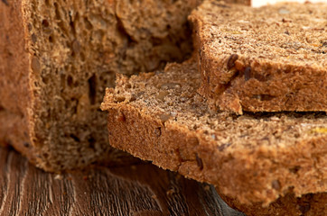 Slices of brown bread on a wooden table