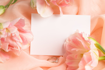 Obraz na płótnie Canvas Tulips with blank card and diamond ring