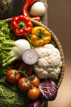 still life with vegetables isolated on brown background
