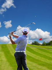Man playing golf against blue sky