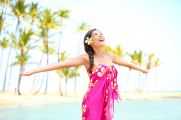 Fototapeta na wymiar Happy woman praising freedom, palm beach in sarong