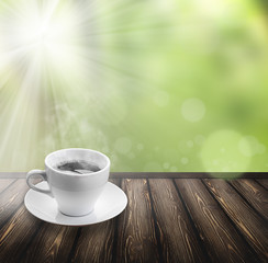 coffee on wood floor with green bokeh .