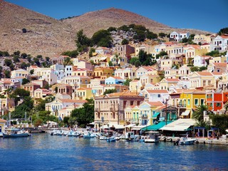 beautiful colorful houses on hill, Symi island, Greece - obrazy, fototapety, plakaty