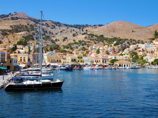 Old harbor with boats at Symi, Greece