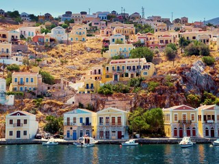 beautiful colorful houses on hill, Symi island, Greece