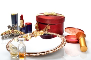 Items for decorative cosmetics, makeup, mirror and flowers