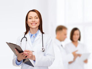 Fototapeta premium smiling female doctor with clipboard