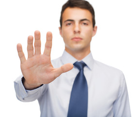 attractive buisnessman making stop gesture