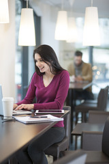 handsome woman using laptop in a cafe