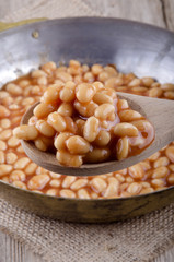 wooden spoon with baked beans