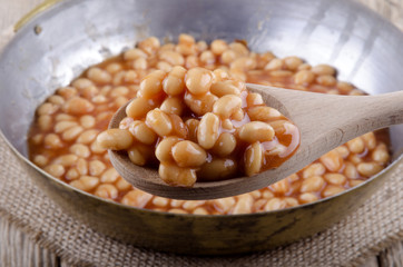 wooden spoon with baked beans