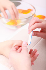 Obraz na płótnie Canvas Beautician filing nails female client. Woman spa beauty salon