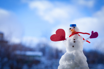 Little happy snowman red heart love symbol outdoor. Winter.
