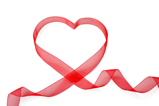 A red ribbon shaping heart , isolated on white background