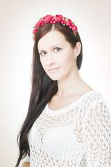 Young beautiful woman with flower wreath on head