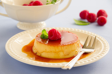Creme caramel with raspberries.