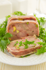 Duck terrine with pistachios and cherries.
