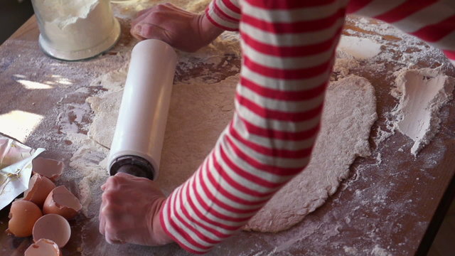 Baker kneading dough with rolling pin, super slow motion,