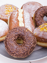 donuts on the platter, top view, white background