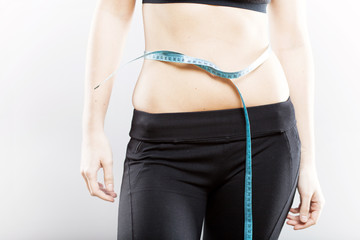 Woman measuring her waist after exercise