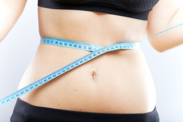 Woman measuring her waist after exercise