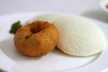 Idli Vada is a South Indian breakfast dish served on banana leaf