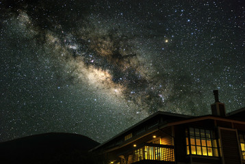 The Milky Way over a mountain house.