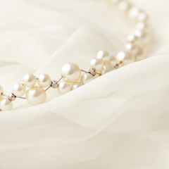 Pearl necklace on white background