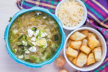 Onion soup with rice, feta cheese, zucchini, croutons, tasty