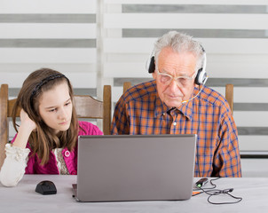 Girl and old man on laptop
