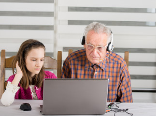 Girl and old man on laptop