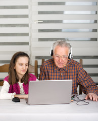 Girl and old man on laptop