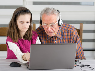 Girl and old man on laptop