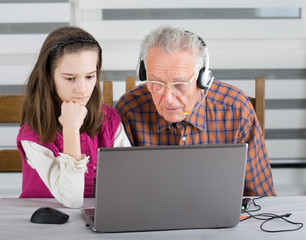 Girl and old man on laptop