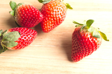 Appetizing strawberry on a wood background.