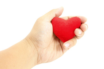 Obraz premium Hand holding small heart shaped pillow isolated on white