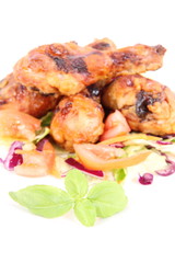 Fried chicken legs with side salad decorated with basil