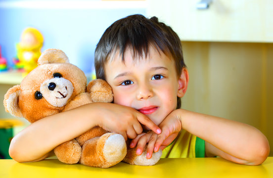 Smiling Boy With A Soft Toy Teddy Bear