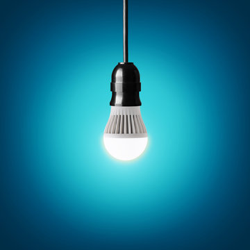 Glowing led bulb on blue background