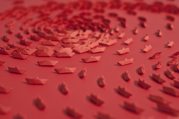 Tiny red paper boats close up