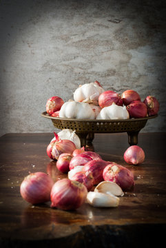 Garlic and onions in a brass tray.