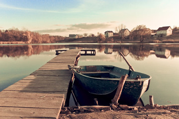 Old fishing boat ashore lake
