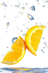 Orange slice splashing into water