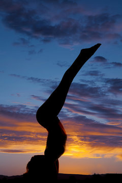 Silhouette woman stand on arms legs up