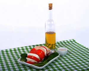 tomato salad with bottle of olive oil