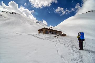 Man near tea house in snowy mountains