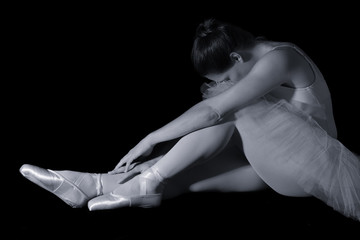 Female dancer sit on floor looking sad in artistic conversion