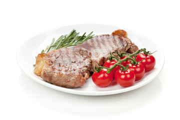 Sirloin steak with rosemary and cherry tomatoes on a plate