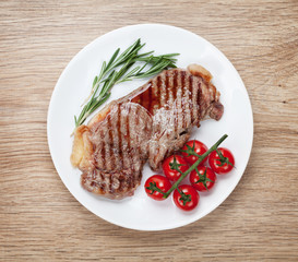 Sirloin steak with rosemary and cherry tomatoes on a plate